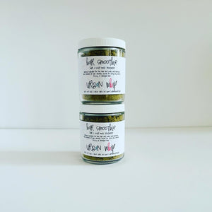 Two jars of Urban Whip hair mask treatment with ingredients like banana, carrot, and honey listed on the labels.